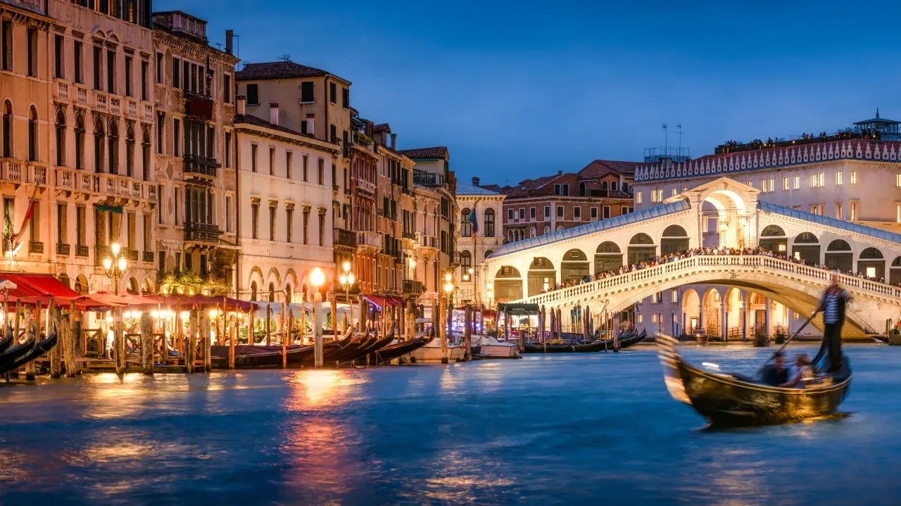 Romantic gondola ride near Rialto Bridge in Venice, Italy